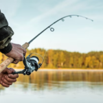 Person fishing with a fishing rod.