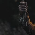 Hand holding a fishing rod displaying its line